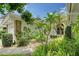 View of the front entrance surrounded by lush, tropical landscaping at 5803 Garden Lakes Palm, Bradenton, FL 34203