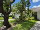 Attractive home with a tile roof, lush landscaping, and a concrete driveway leading to a garage at 5803 Garden Lakes Palm, Bradenton, FL 34203