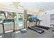 Bright gym features modern treadmills and large windows overlooking the community pool at 5803 Garden Lakes Palm, Bradenton, FL 34203