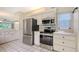 Well-equipped kitchen with stainless steel appliances and white cabinetry offering plenty of storage at 5803 Garden Lakes Palm, Bradenton, FL 34203