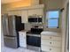 Kitchen with stainless steel appliances including refrigerator, range, and microwave at 5803 Garden Lakes Palm, Bradenton, FL 34203