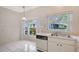 Bright eat-in kitchen with large window with backyard view and retro appliances at 5803 Garden Lakes Palm, Bradenton, FL 34203