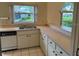 The kitchen features ample counter space, updated appliances, and nice views at 5803 Garden Lakes Palm, Bradenton, FL 34203