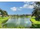 Scenic view of a lake surrounded by lush greenery and residential properties at 5803 Garden Lakes Palm, Bradenton, FL 34203