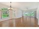 Spacious living room featuring hardwood floors, many windows, and a ceiling fan at 5803 Garden Lakes Palm, Bradenton, FL 34203