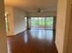 Spacious living room with hardwood floors, recessed lighting, and large sliding glass doors leading to the lanai at 5803 Garden Lakes Palm, Bradenton, FL 34203