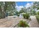 Community pool area with lounge chairs, tables, and a view of the pool and surrounding landscape at 5803 Garden Lakes Palm, Bradenton, FL 34203
