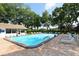 Community pool with refreshing water, surrounded by lounge chairs and mature trees at 5803 Garden Lakes Palm, Bradenton, FL 34203
