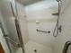 Clean white tiled walk-in shower featuring a grab bar at 5803 Garden Lakes Palm, Bradenton, FL 34203
