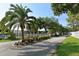 Well-maintained street view shows guard house, mature landscaping, and entrance to community at 5803 Garden Lakes Palm, Bradenton, FL 34203