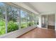 Enclosed sunroom offering panoramic view of the lush greenery of the backyard at 5803 Garden Lakes Palm, Bradenton, FL 34203
