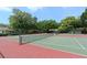 Well-maintained community tennis courts surrounded by mature trees, perfect for outdoor recreation at 5803 Garden Lakes Palm, Bradenton, FL 34203