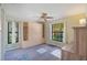 Inviting bedroom with built-in wardrobe, ceiling fan and large windows offering plenty of natural light at 6065 Marella Ct, Sarasota, FL 34243