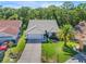Well-maintained home with lush lawn, mature landscaping, and a pristine driveway at 6065 Marella Ct, Sarasota, FL 34243