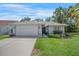 Charming single-story home featuring a well-manicured lawn, tile roof, and attached two-car garage at 6065 Marella Ct, Sarasota, FL 34243