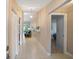 Bright hallway with tiled flooring, a decorative shelf, and an elegant pendant light fixture at 6065 Marella Ct, Sarasota, FL 34243