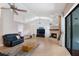 Bright living room featuring a fireplace, ceiling fan, and sliding doors to the outdoor space at 6065 Marella Ct, Sarasota, FL 34243