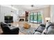 Comfortable living room featuring a fireplace, vaulted ceiling, and access to the pool area at 6065 Marella Ct, Sarasota, FL 34243