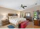 Comfortable main bedroom with a large bed, ceiling fan, and natural light from the windows at 6065 Marella Ct, Sarasota, FL 34243