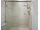 Bathroom with a modern shower featuring sleek glass doors and tile at 6065 Marella Ct, Sarasota, FL 34243
