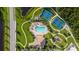 Aerial view of the community featuring pool, tennis courts, playground, and clubhouse with manicured lawns at 616 Dogwood Run, Bradenton, FL 34212
