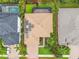 Aerial view of home with solar panels, screened-in lanai, brick driveway and mature landscaping at 616 Dogwood Run, Bradenton, FL 34212