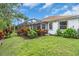 Backyard view with lush landscaping, a screened-in porch, and ample green space at 616 Dogwood Run, Bradenton, FL 34212