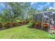 Well-manicured backyard with lush lawn, mature trees, and vibrant landscaping at 616 Dogwood Run, Bradenton, FL 34212