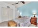 Bedroom featuring a bed, a ceiling fan, a coastal theme, and blue accent wall at 616 Dogwood Run, Bradenton, FL 34212