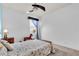 Bedroom with a ceiling fan, a rocking horse, neutral decor, and a window with blue curtains at 616 Dogwood Run, Bradenton, FL 34212