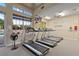 Bright cardio room featuring treadmills, large windows, ceiling fan, and wall-mounted TV for an engaging workout at 616 Dogwood Run, Bradenton, FL 34212