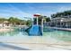 View of the community pool with zero entry access, waterslide and clubhouse at 616 Dogwood Run, Bradenton, FL 34212