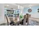 Open dining area with ship wheel decor open to the Gathering room at 616 Dogwood Run, Bradenton, FL 34212