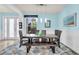 Bright dining room with light blue walls featuring a dark table and chair set at 616 Dogwood Run, Bradenton, FL 34212