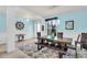 Light and airy dining room with an ornate table, bench, and chairs at 616 Dogwood Run, Bradenton, FL 34212