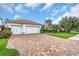 Spacious two-car garage with brick paver driveway and manicured landscaping enhances the home's curb appeal at 616 Dogwood Run, Bradenton, FL 34212
