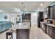 Kitchen with granite countertops, tile backsplash, stainless steel appliances, and adjacent living space at 616 Dogwood Run, Bradenton, FL 34212