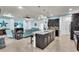 Open kitchen features a large island, stainless sink, and plenty of counter space with barstool seating at 616 Dogwood Run, Bradenton, FL 34212