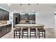 Modern kitchen featuring a granite island with seating and pendant lighting at 616 Dogwood Run, Bradenton, FL 34212