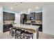 Modern kitchen with a large island, granite countertops, and dark wood cabinets at 616 Dogwood Run, Bradenton, FL 34212