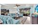 Open living space with blue couches and access to the modern kitchen at 616 Dogwood Run, Bradenton, FL 34212