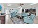 Open-concept living space with blue couches open to the modern kitchen at 616 Dogwood Run, Bradenton, FL 34212