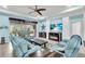 Cozy living room with blue couches, ceiling fan, and screened lanai access at 616 Dogwood Run, Bradenton, FL 34212