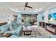 Bright living room featuring comfortable blue couches and a screened lanai at 616 Dogwood Run, Bradenton, FL 34212