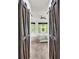 View of main bedroom through doorway with barn doors at 616 Dogwood Run, Bradenton, FL 34212