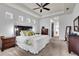 Large main bedroom with carpet, tray ceiling, and modern decor at 616 Dogwood Run, Bradenton, FL 34212