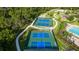 Aerial view of community pickleball courts with easy access walking path and trees offering shade at 616 Dogwood Run, Bradenton, FL 34212