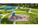 Aerial view of playground in the community with easy access walking path and mature trees offering shade at 616 Dogwood Run, Bradenton, FL 34212