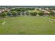 Aerial view of community soccer field with pond and walking path at 616 Dogwood Run, Bradenton, FL 34212