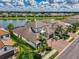 Beautiful waterfront home featuring lush landscaping and stunning lake views at 6318 Rivo Lakes Blvd, Sarasota, FL 34241